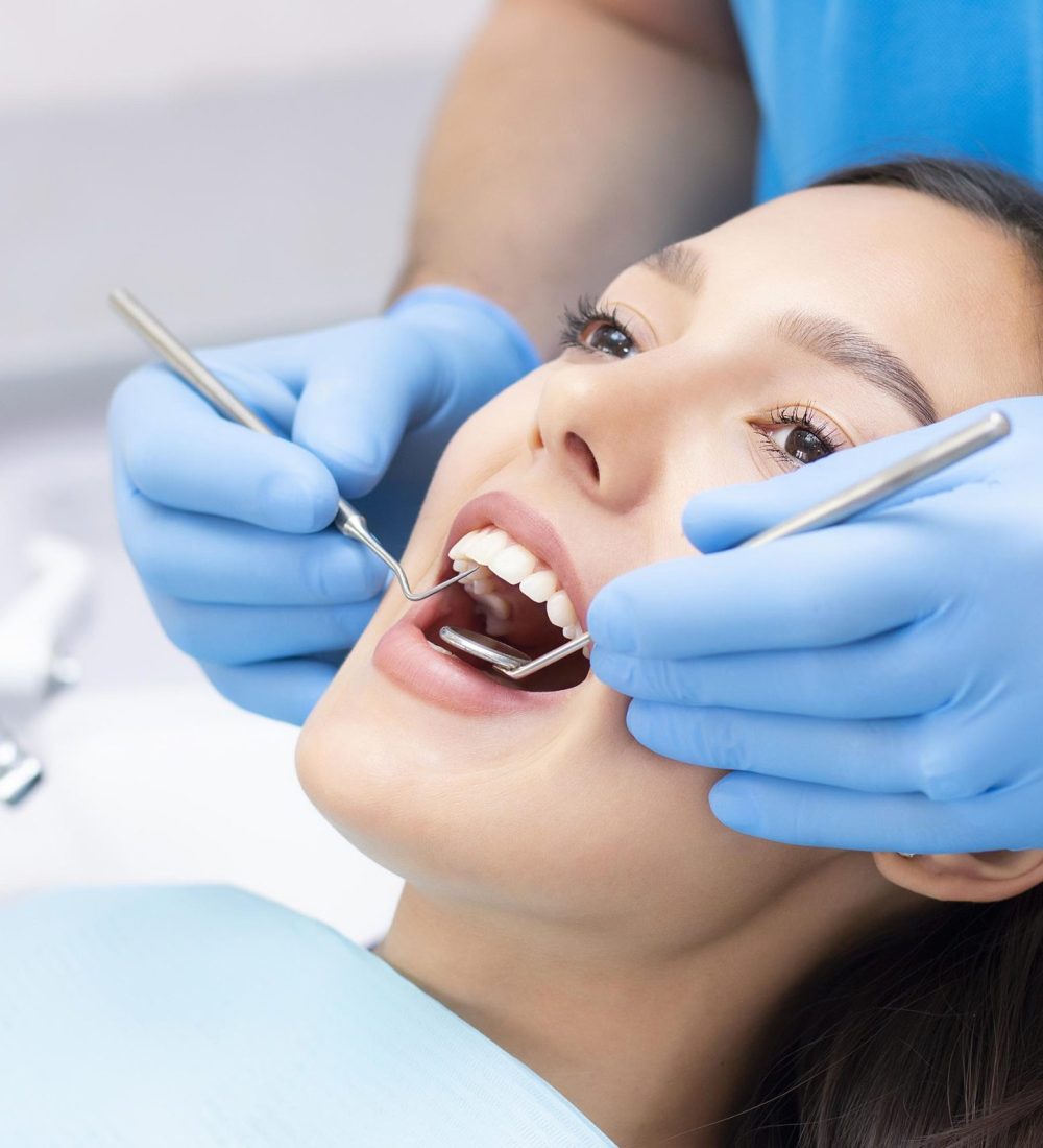 young-female-patient-with-pretty-smile-examining-dental-inspection-dentist-clinic-healthy-teeth-medicine-scaled.jpg